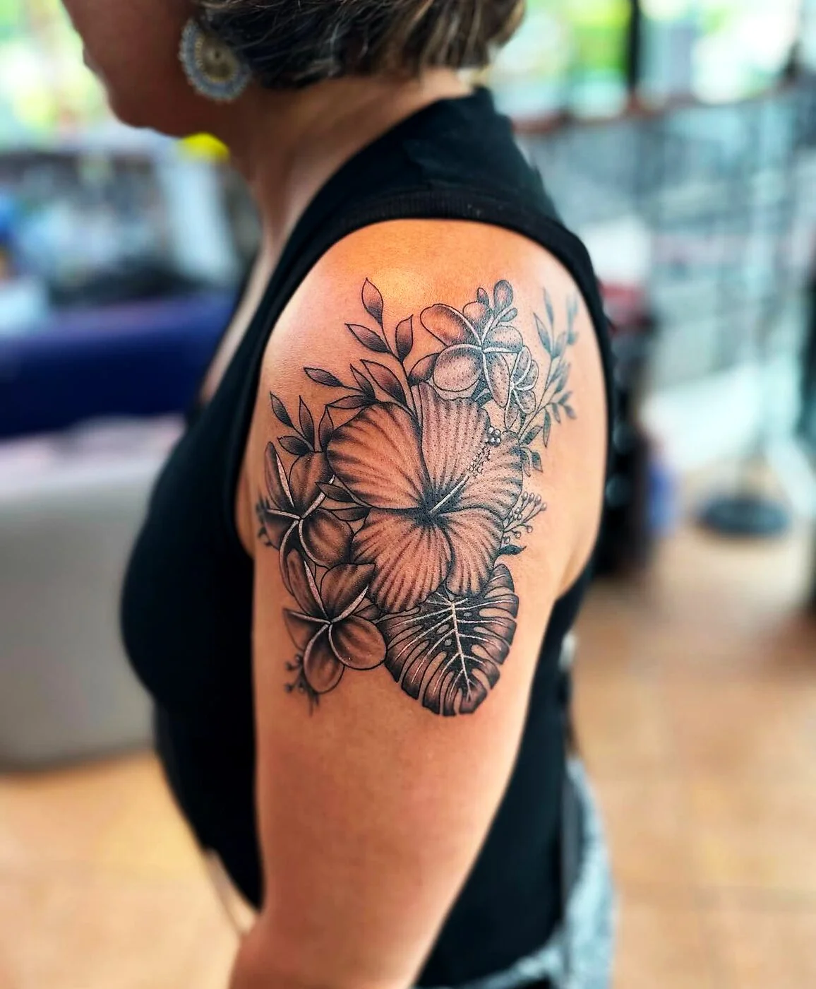 Black & Grey hibiscus, plumeria and monstera bouquet tattoo on shoulder by 2bit (Chris Curren) at Lost at Sea Tattoo, Chinatown, Honolulu Black & Grey hibiscus, plumeria and monstera bouquet tattoo on shoulder by 2bit (Chris Curren) at Lost at Sea Tattoo, Chinatown, Honolulu