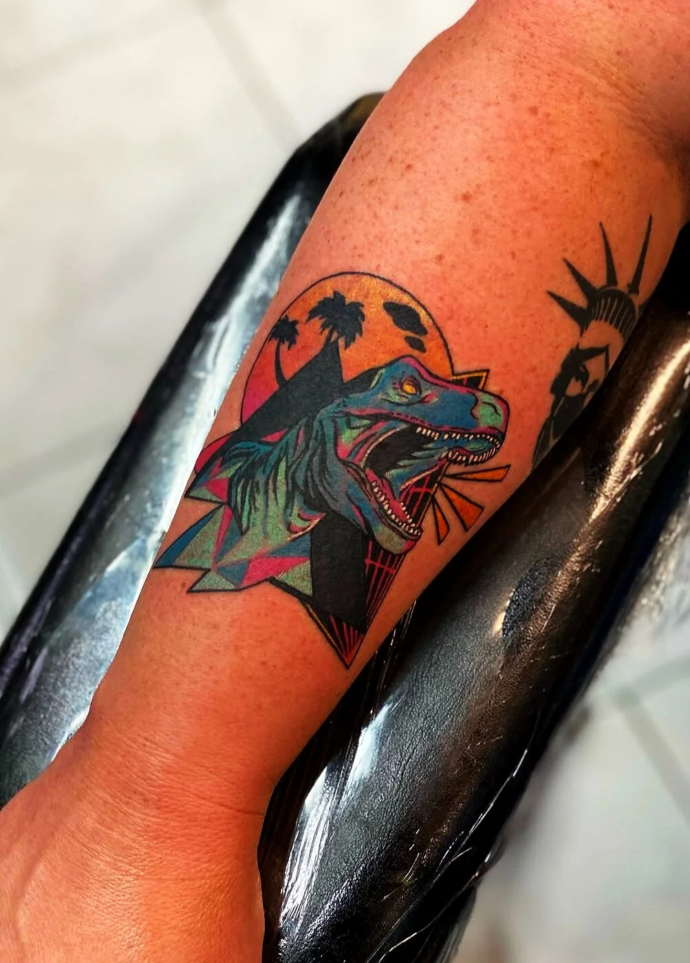 Neo-Traditional synthwave 80s velociraptor with palm trees and sunset tattoo on forearm by 2bit (Chris Curren) at Lost at Sea Tattoo, Chinatown, Honolulu Neo-Traditional synthwave 80s velociraptor with palm trees and sunset tattoo on forearm by 2bit (Chris Curren) at Lost at Sea Tattoo, Chinatown, Honolulu